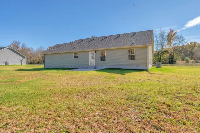a view of a house with yard and tree s