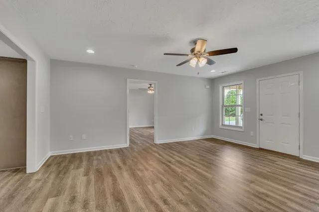 wooden floor in an empty room with a window