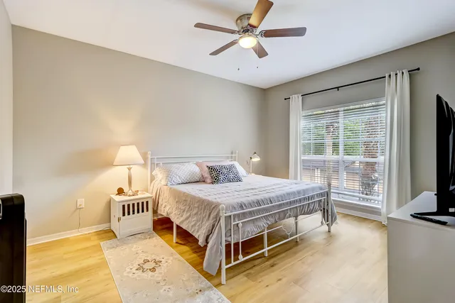 a bedroom with a bed and a tv on the dresser