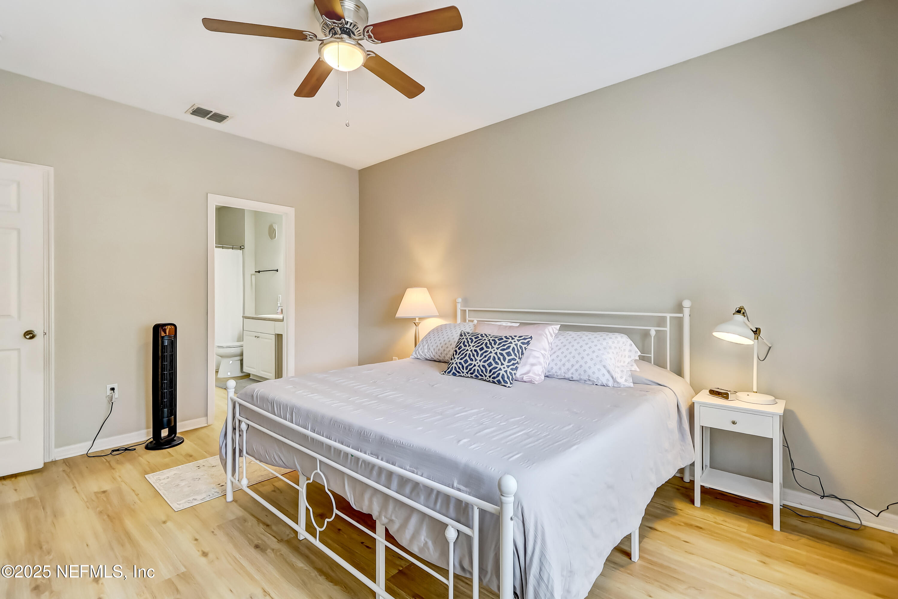 10961 Burnt Mill Road, Unit 328 Jacksonville, FL 32256 - Photo 12 of 33 a bedroom with a bed and a chandelier