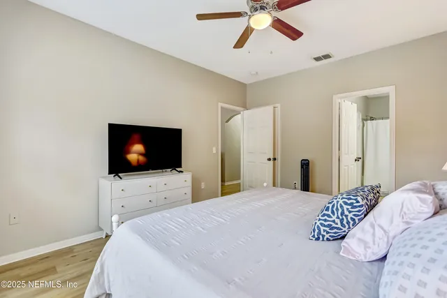 a bedroom with a bed and a flat screen tv