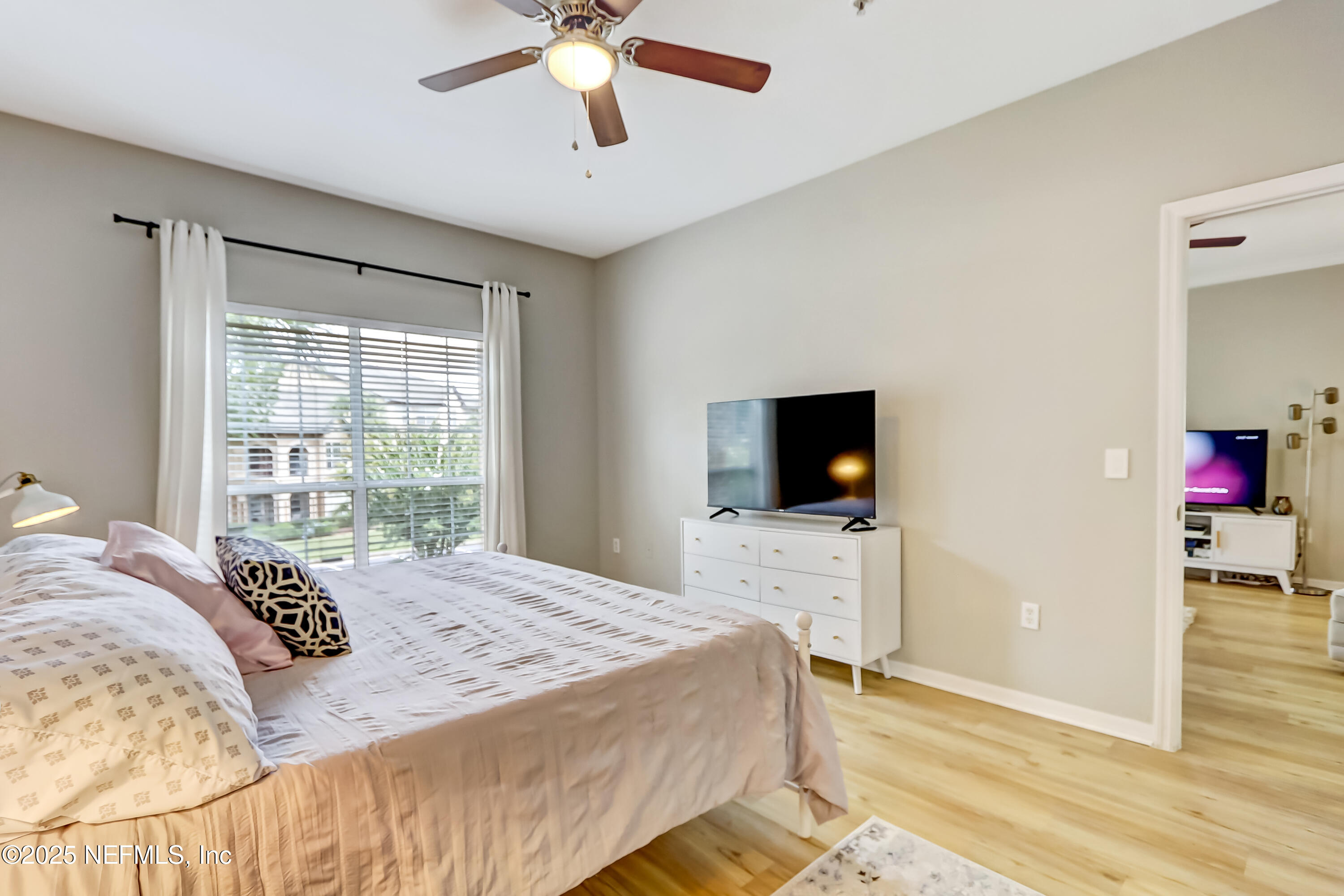 10961 Burnt Mill Road, Unit 328 Jacksonville, FL 32256 - Photo 14 of 33 a bedroom with a bed and a flat screen tv