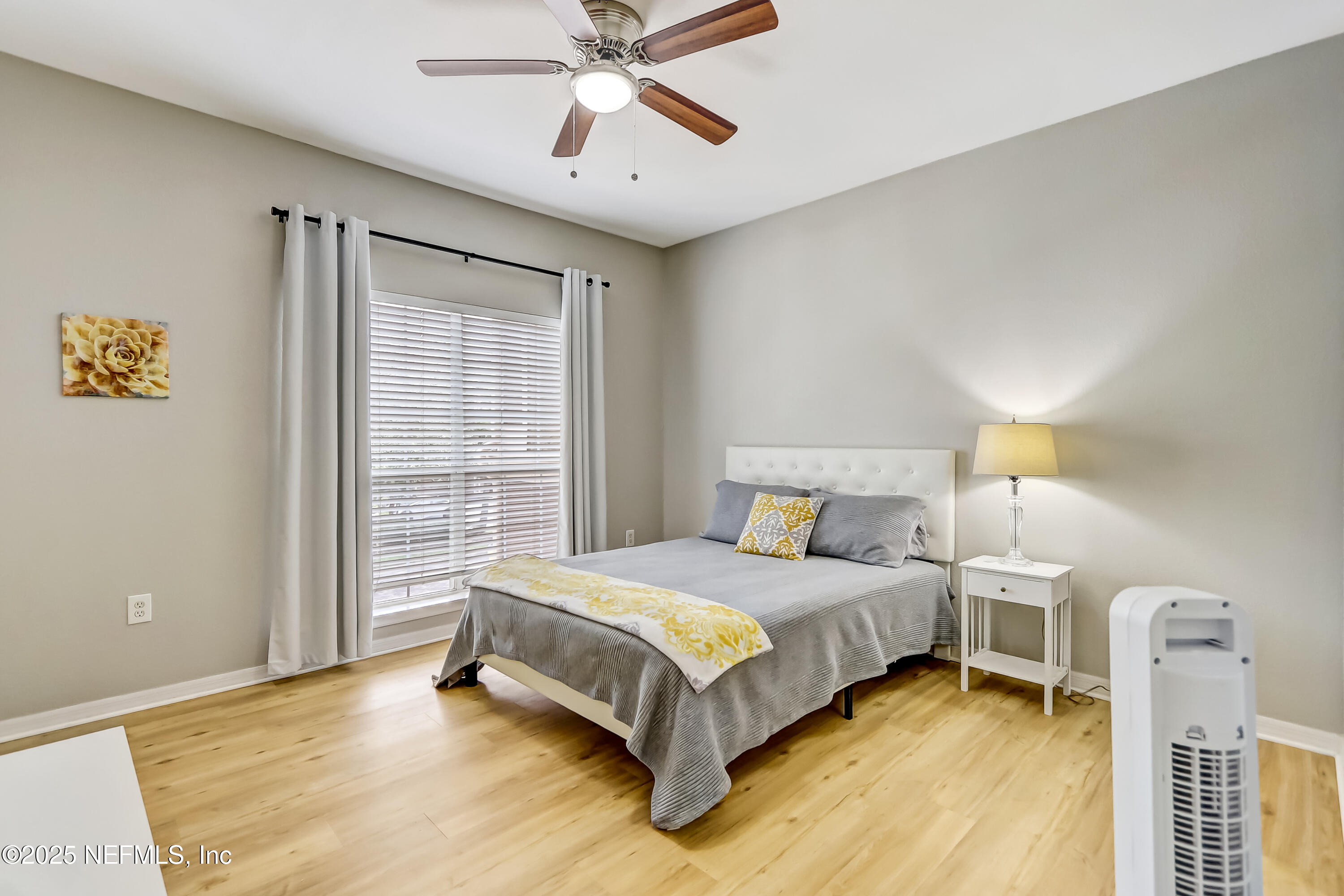 10961 Burnt Mill Road, Unit 328 Jacksonville, FL 32256 - Photo 17 of 33 a bedroom with a bed and a chandelier