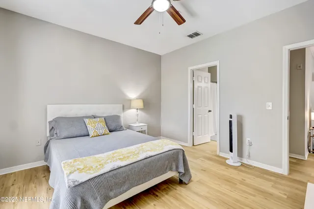 a bedroom with a large bed and a chandelier