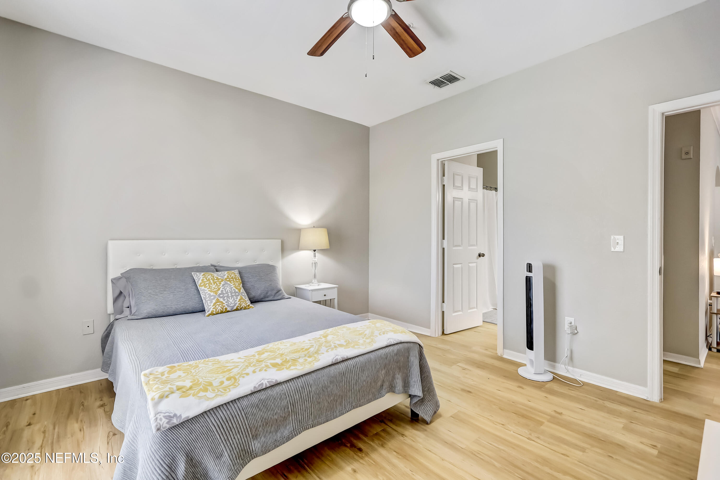 10961 Burnt Mill Road, Unit 328 Jacksonville, FL 32256 - Photo 18 of 33 a bedroom with a large bed and a chandelier