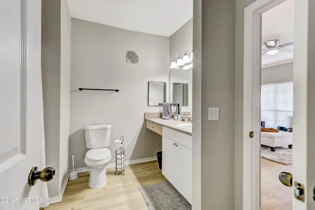a spacious bathroom with a toilet sink and a mirror