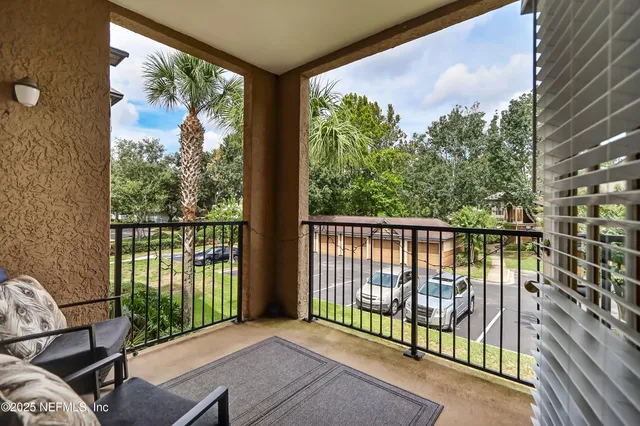 a view of a balcony with wooden floor