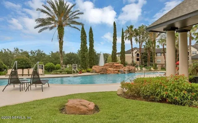 a swimming pool with outdoor seating and yard