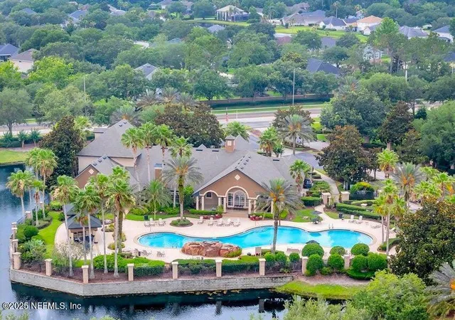 a view of house with garden space and lake view