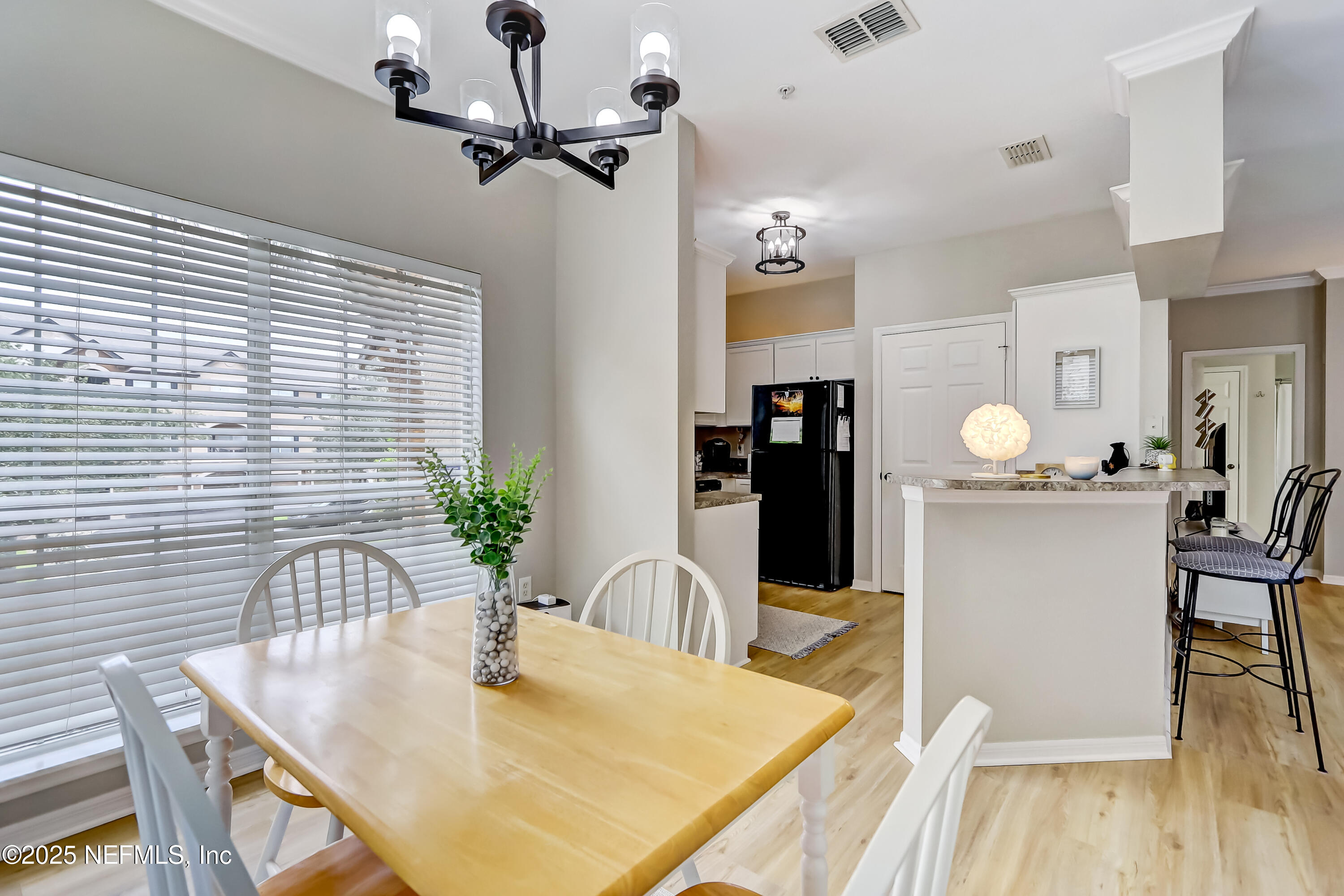 10961 Burnt Mill Road, Unit 328 Jacksonville, FL 32256 - Photo 9 of 33 a dining room with furniture and wooden floor