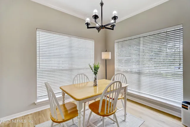 a dining room with furniture and window