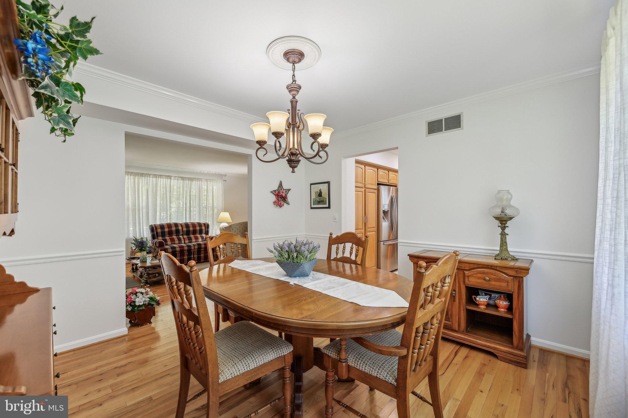 9202 Stone Spring Lane Pasadena, MD 21122 - Photo 12 of 43 a view of a dining room with furniture and wooden floor