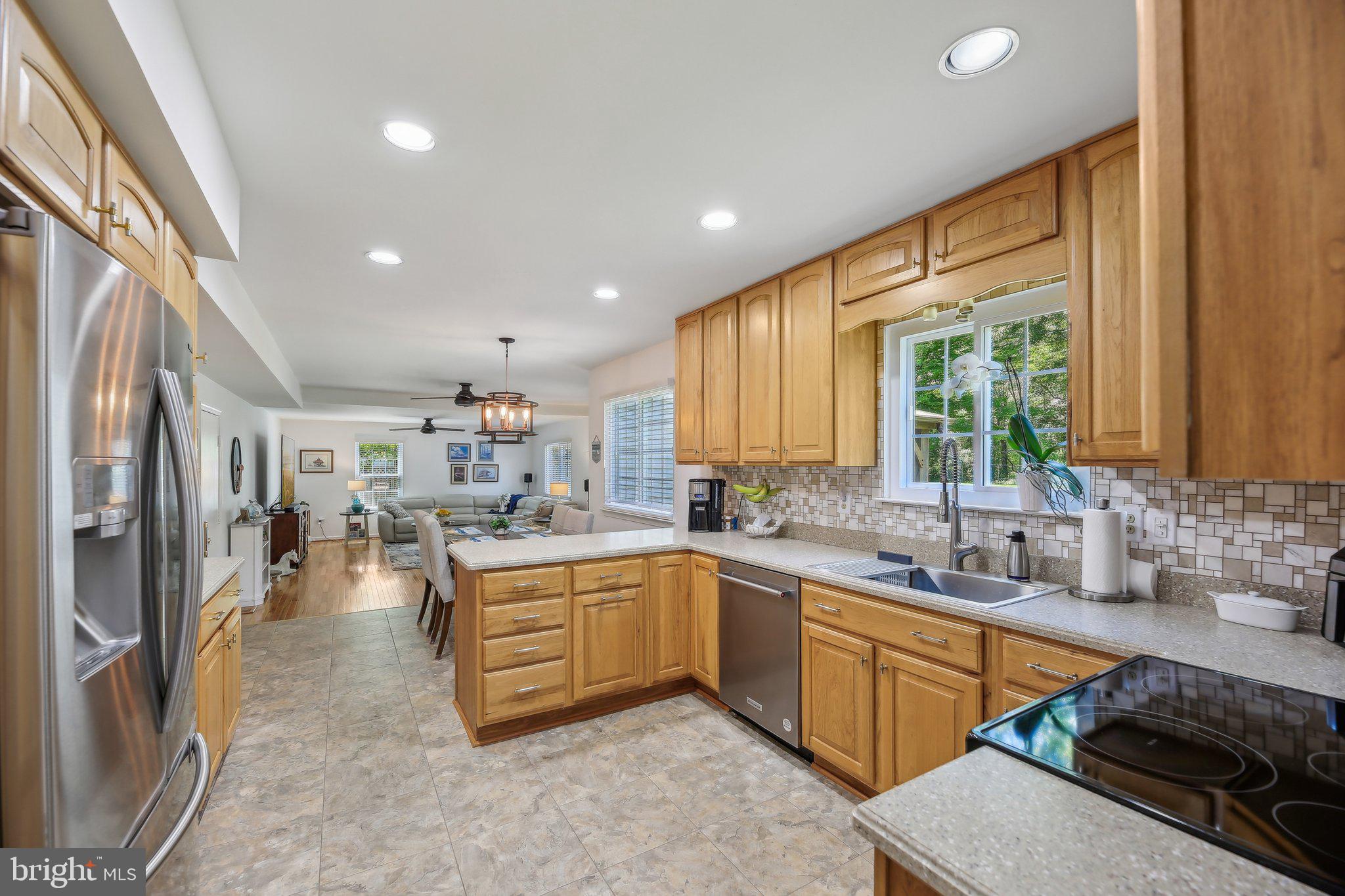 9202 Stone Spring Lane Pasadena, MD 21122 - Photo 13 of 43 a kitchen with lots of counter top space and a sink