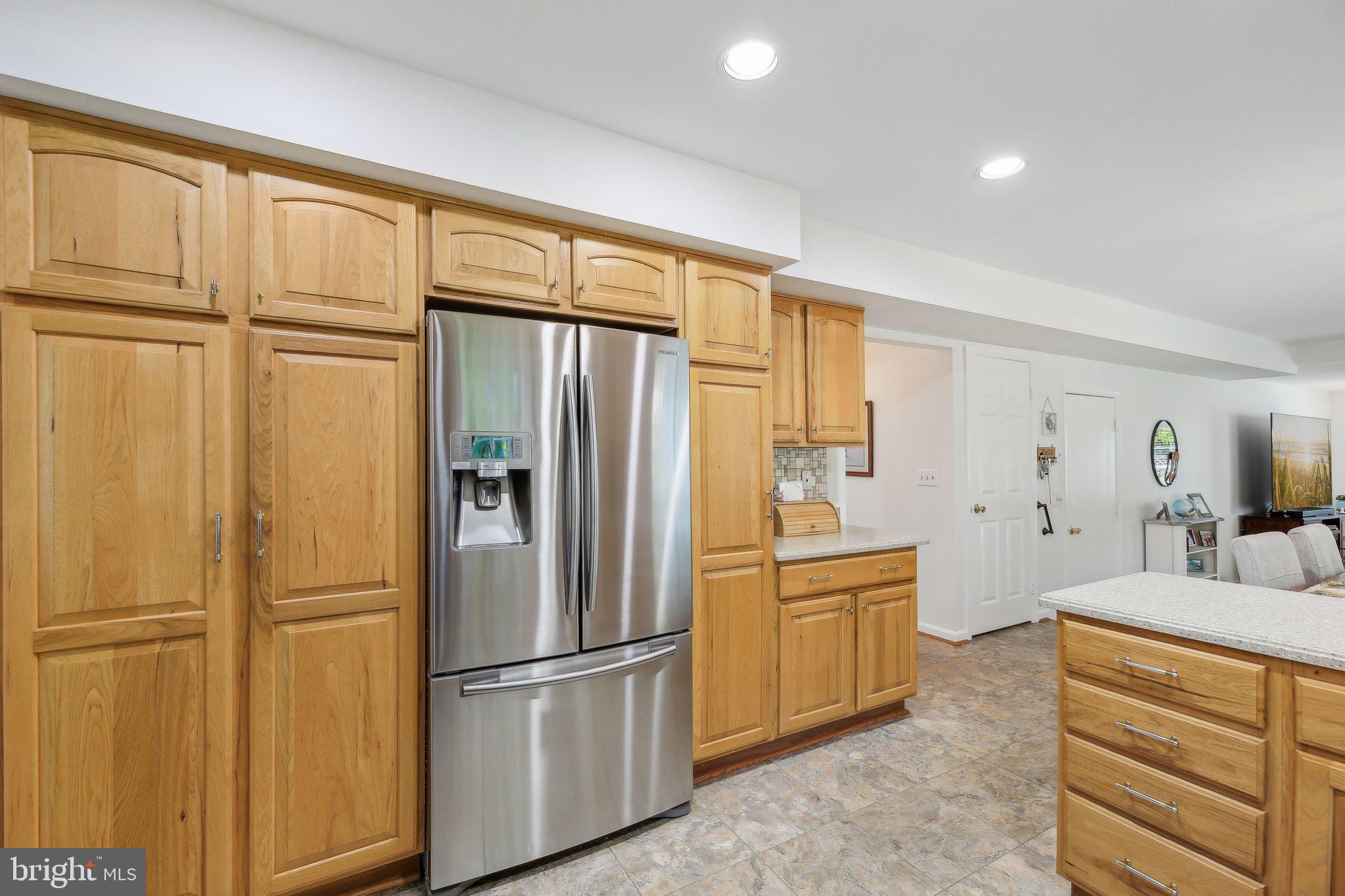 9202 Stone Spring Lane Pasadena, MD 21122 - Photo 15 of 43 a kitchen with stainless steel appliances a refrigerator and cabinets