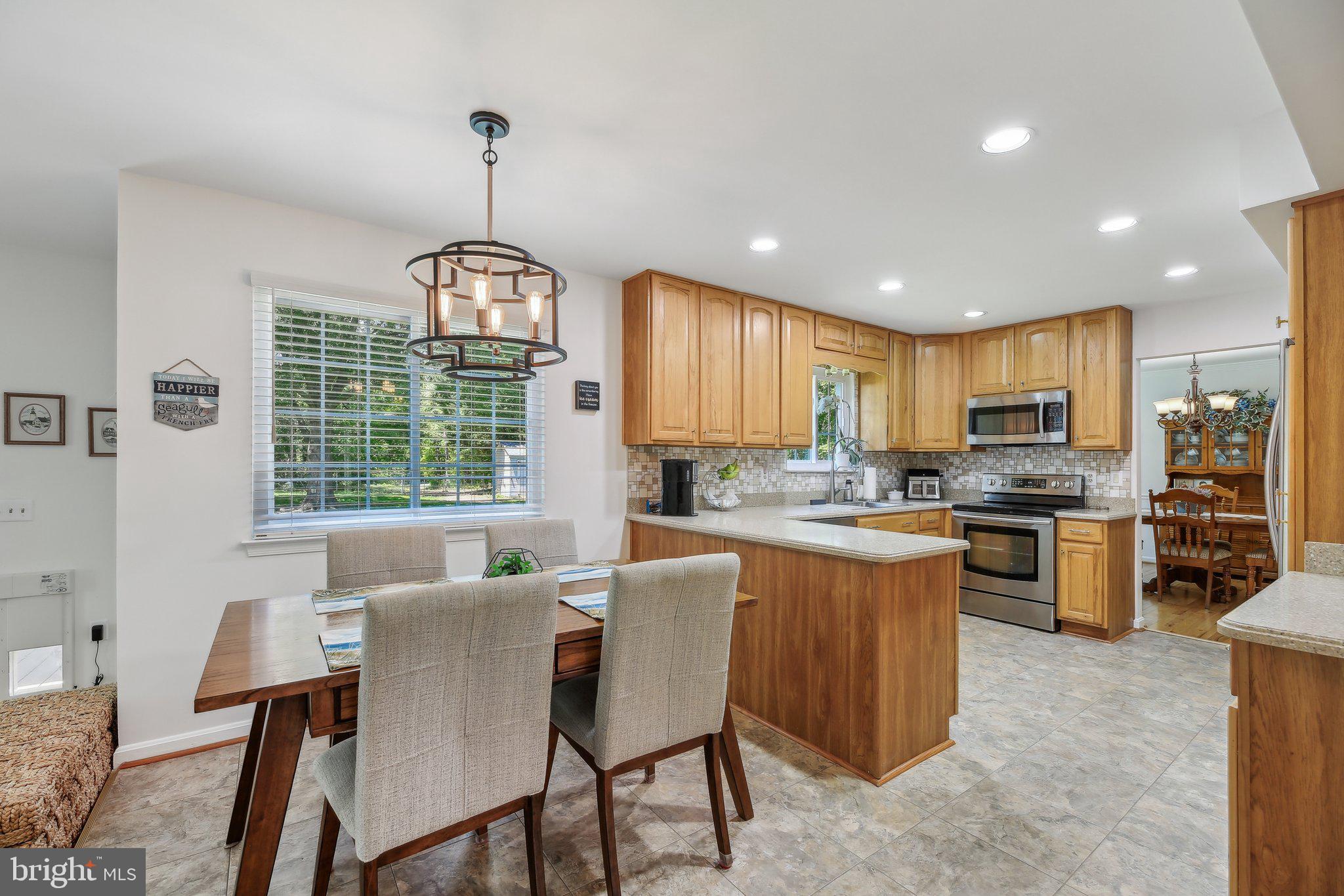 9202 Stone Spring Lane Pasadena, MD 21122 - Photo 16 of 43 a kitchen with counter top space a sink appliances and cabinets