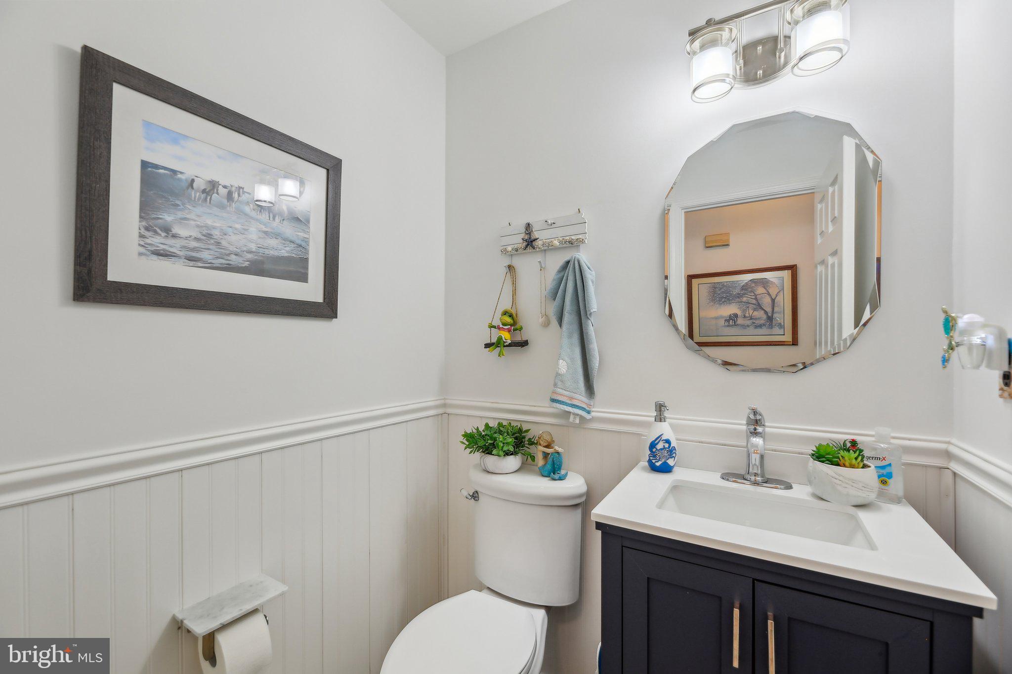 9202 Stone Spring Lane Pasadena, MD 21122 - Photo 18 of 43 a bathroom with a sink mirror and toilet