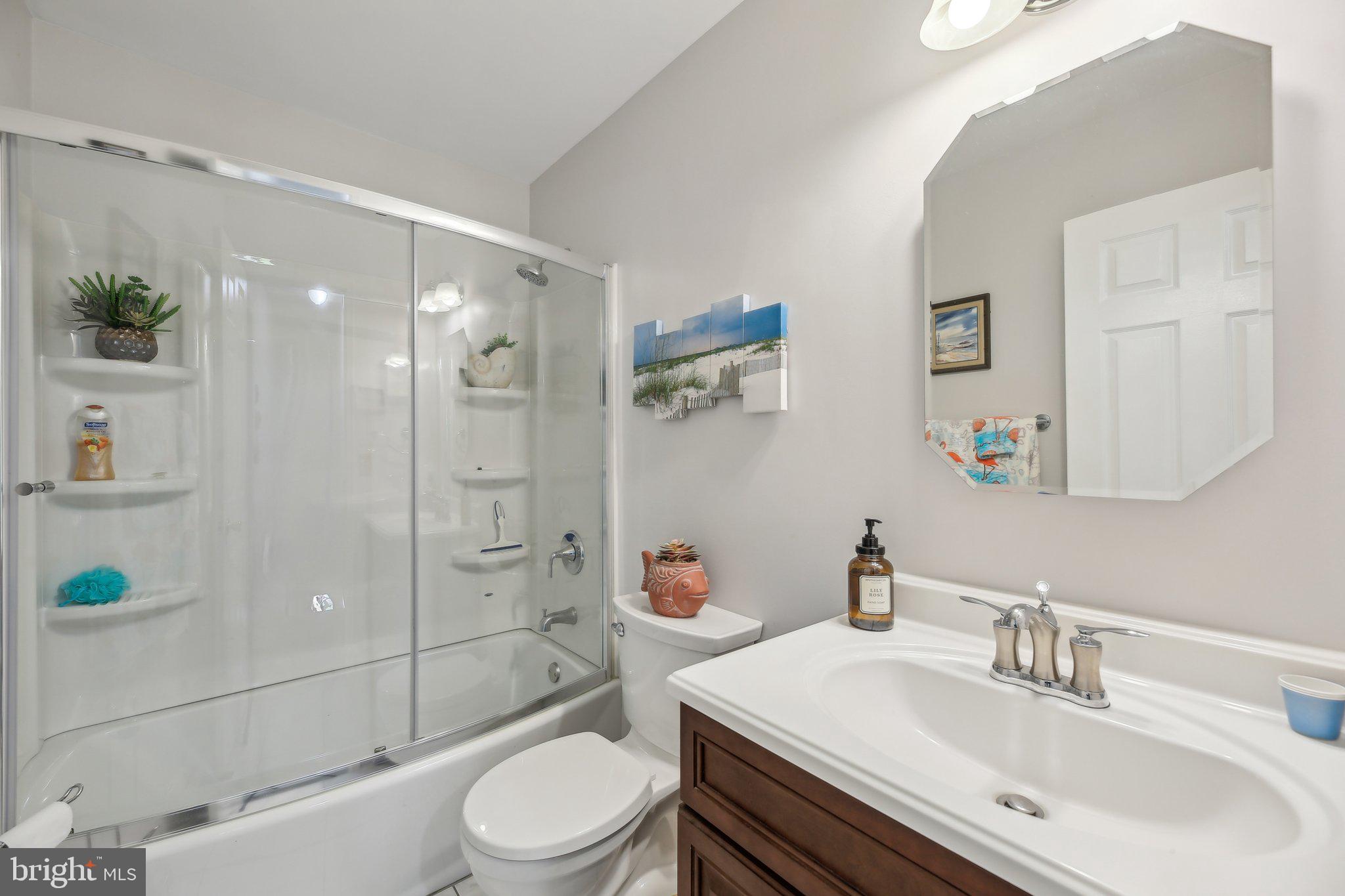 9202 Stone Spring Lane Pasadena, MD 21122 - Photo 20 of 43 a bathroom with a sink a toilet and shower