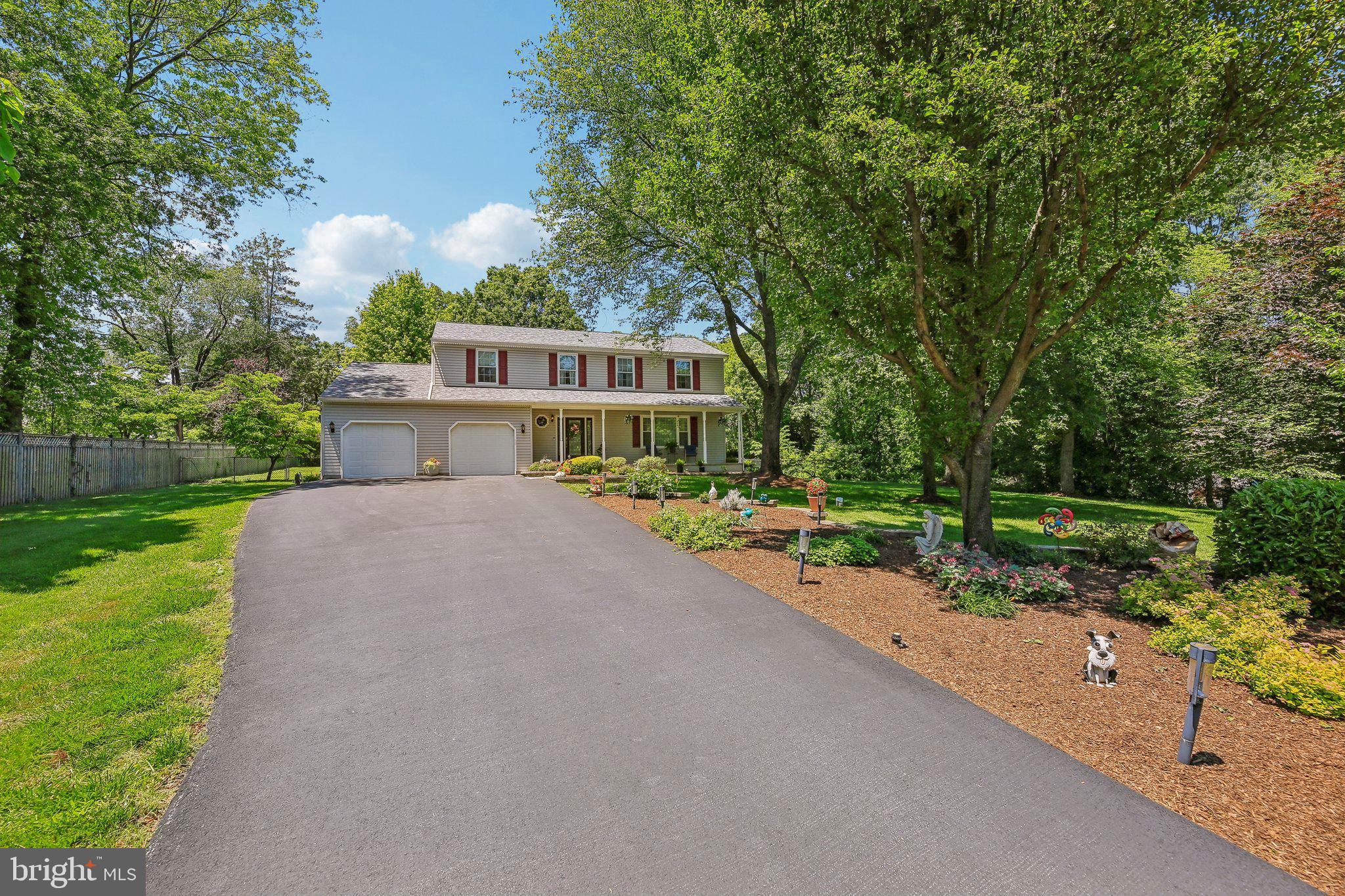 9202 Stone Spring Lane Pasadena, MD 21122 - Photo 2 of 43 a view of a house with a yard and large trees