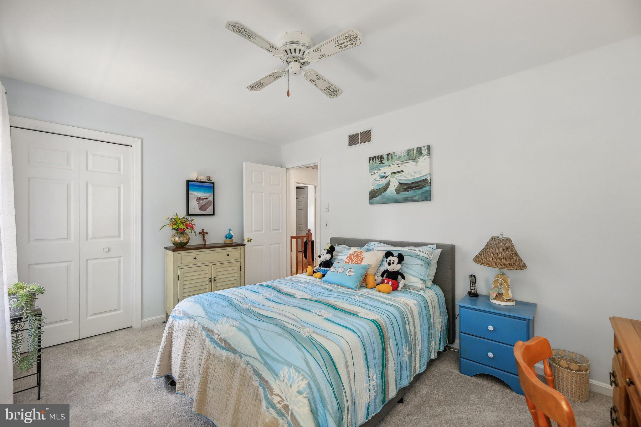9202 Stone Spring Lane Pasadena, MD 21122 - Photo 22 of 43 a bedroom with a bed and a chandelier