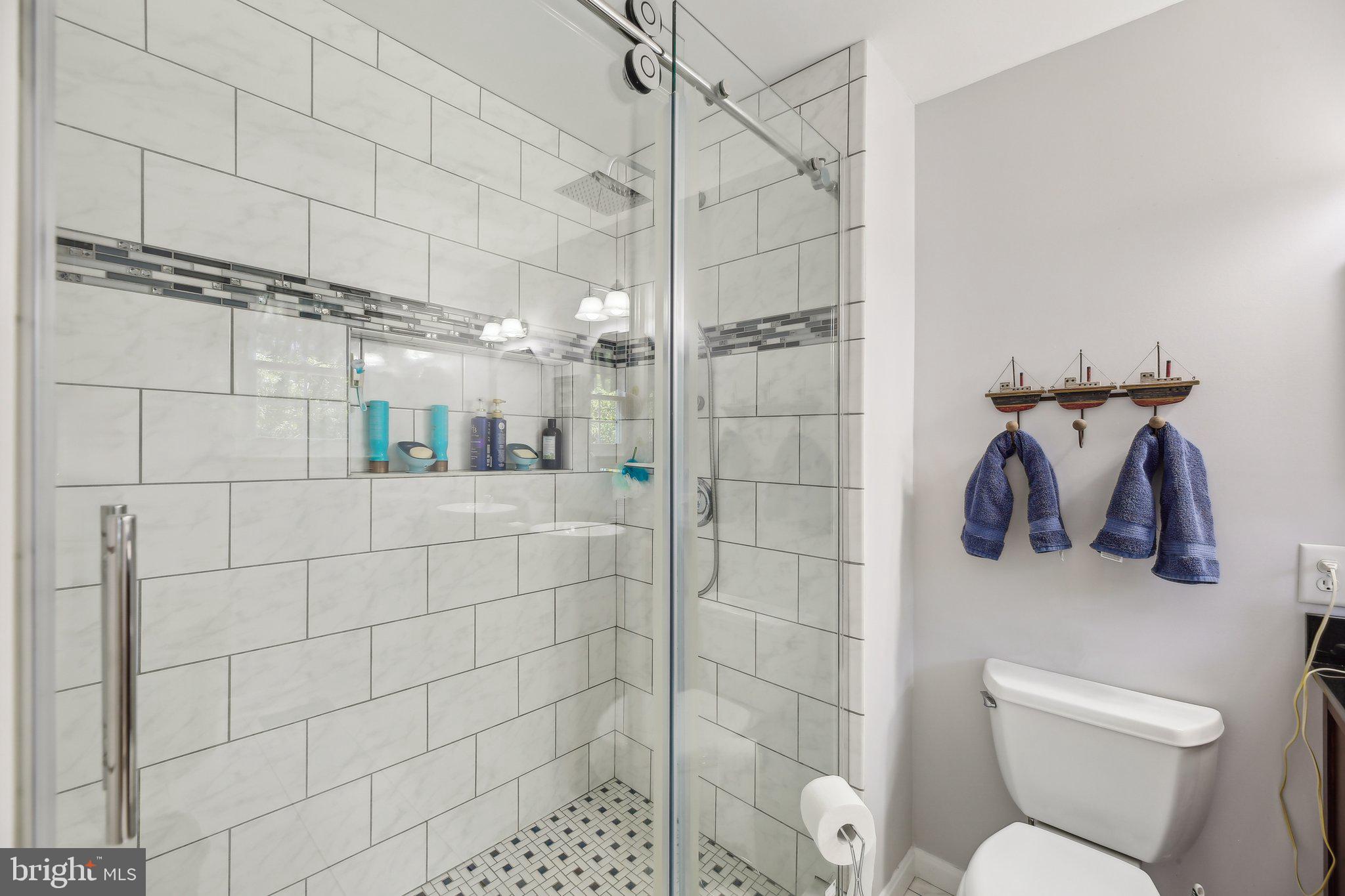 9202 Stone Spring Lane Pasadena, MD 21122 - Photo 26 of 43 a bathroom with a toilet and shower