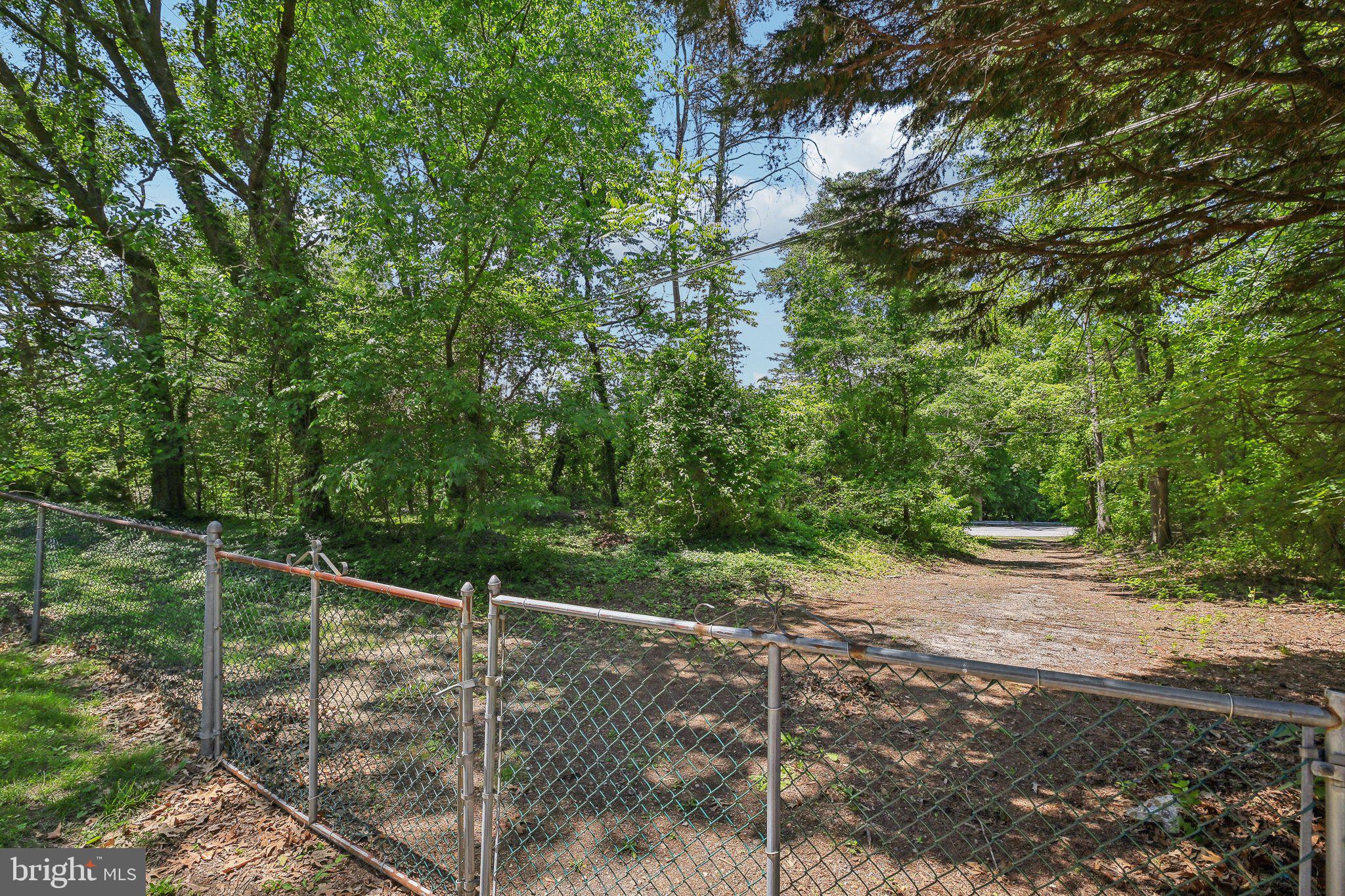 9202 Stone Spring Lane Pasadena, MD 21122 - Photo 34 of 43 a wooden deck with trees