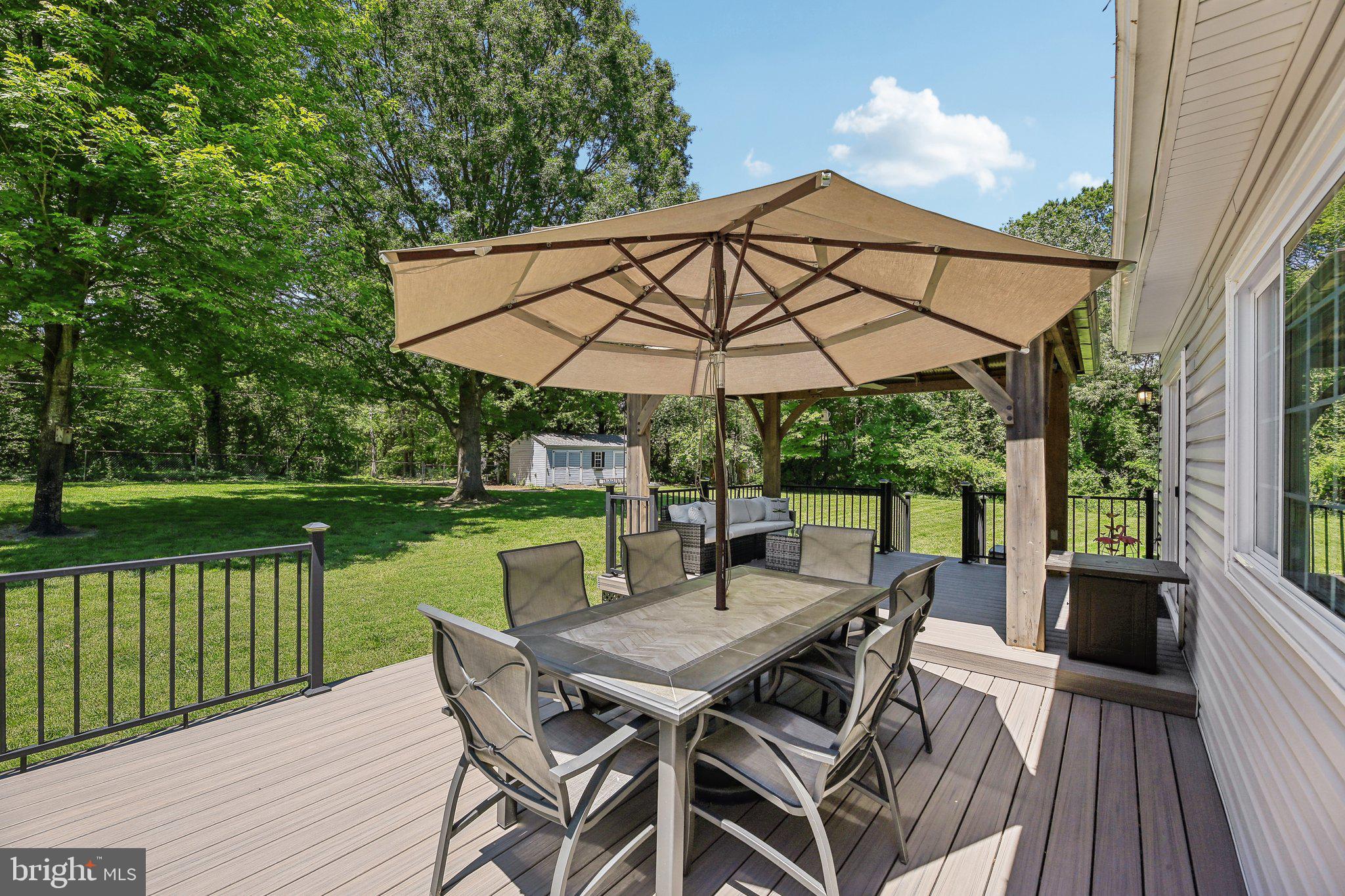 9202 Stone Spring Lane Pasadena, MD 21122 - Photo 40 of 43 a view of a chair and table on the deck
