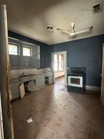 a kitchen with stainless steel appliances granite countertop a stove sink and cabinets