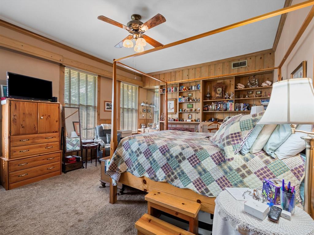 111 Munns Powell, TX 75153 - Photo 12 of 39 a bedroom with a bed a flat screen tv and a dresser