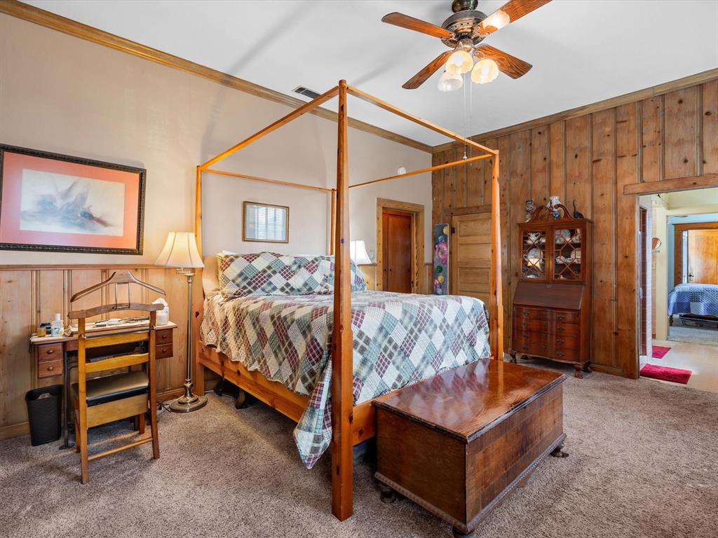 111 Munns Powell, TX 75153 - Photo 13 of 39 a bedroom with a bed and a chandelier