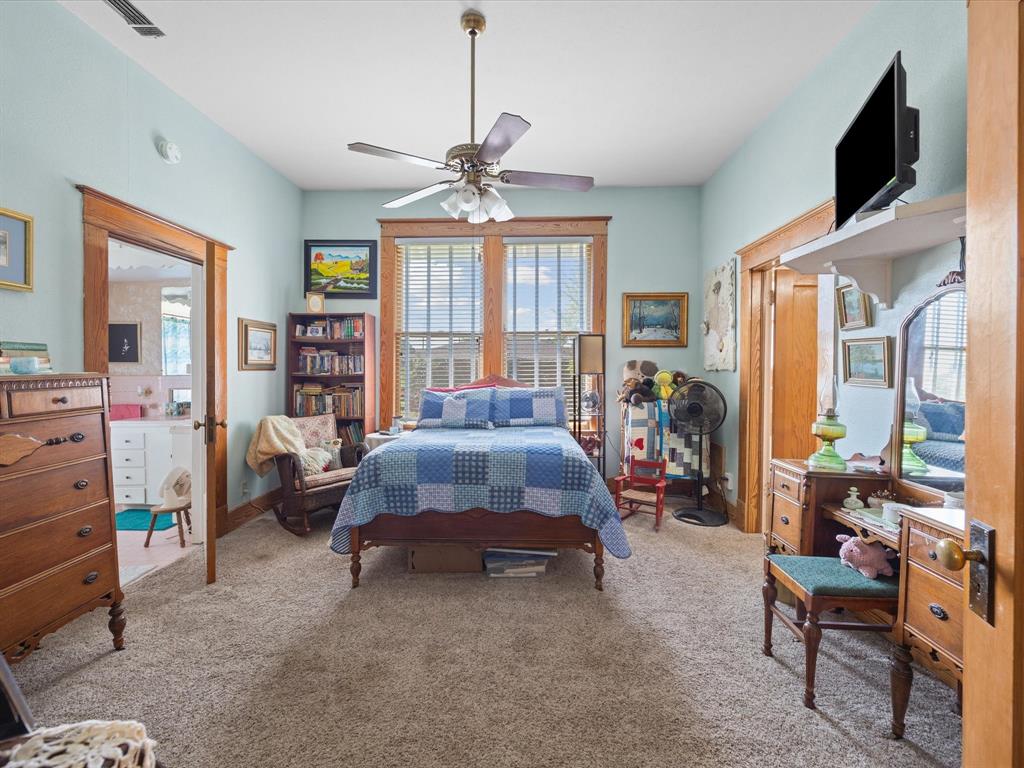 111 Munns Powell, TX 75153 - Photo 16 of 39 a bedroom with a bed a flat screen tv and a large window