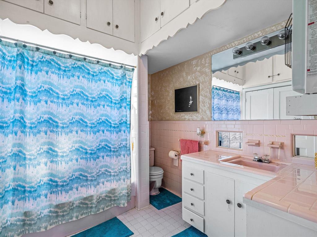 111 Munns Powell, TX 75153 - Photo 18 of 39 a bathroom with a sink mirror and shower