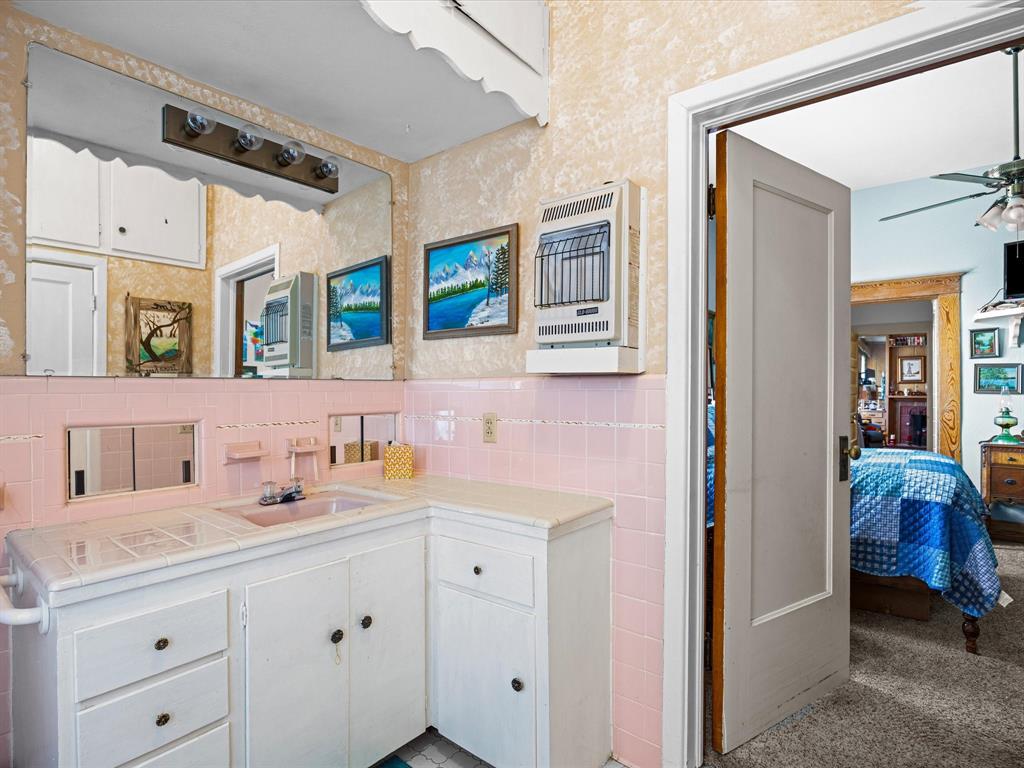 111 Munns Powell, TX 75153 - Photo 19 of 39 a en suite bathroom with a double vanity sink and a mirror