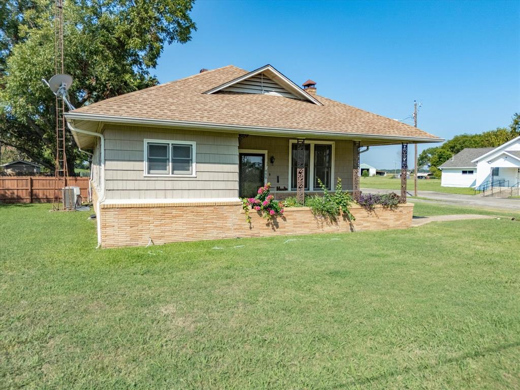 111 Munns Powell, TX 75153 - Photo 38 of 39 a front view of a house with a garden and plants