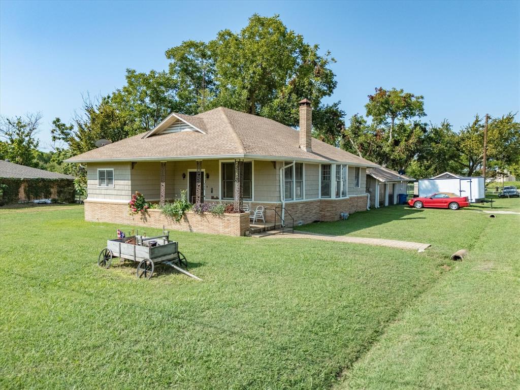 111 Munns Powell, TX 75153 - Photo 39 of 39 a front view of a house with a yard table and chairs