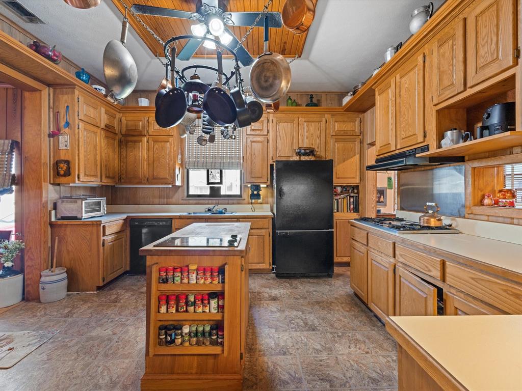 111 Munns Powell, TX 75153 - Photo 10 of 39 a kitchen with stainless steel appliances granite countertop a sink a stove and a refrigerator