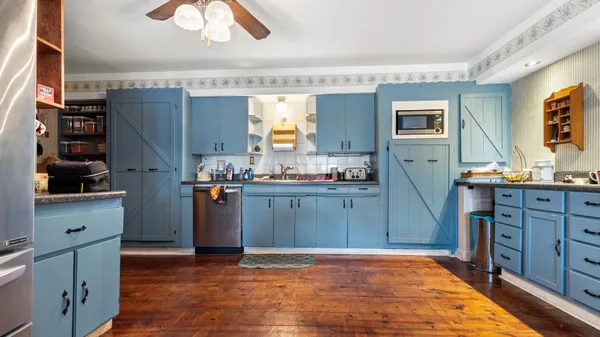 a kitchen with stainless steel appliances granite countertop a refrigerator and a stove