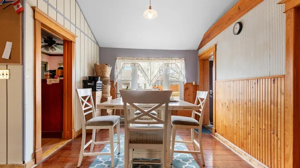 a dining room with furniture and wooden floor