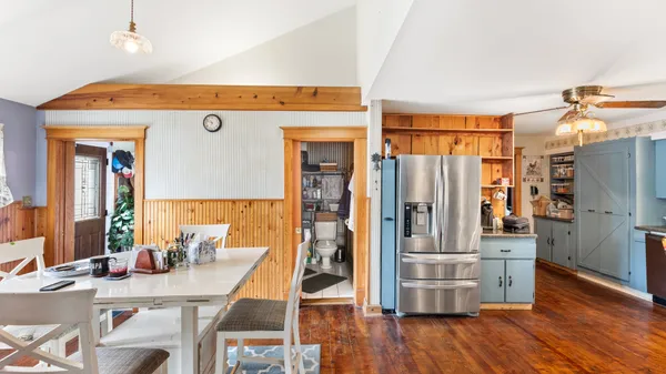 a view of kitchen with furniture and wooden floor