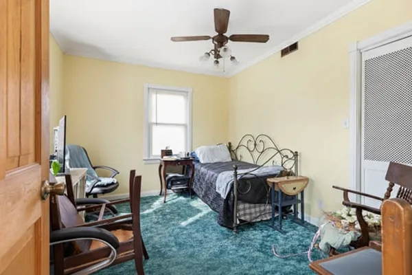 a bedroom with bed and a window