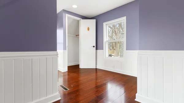a view of hallway with wooden floor