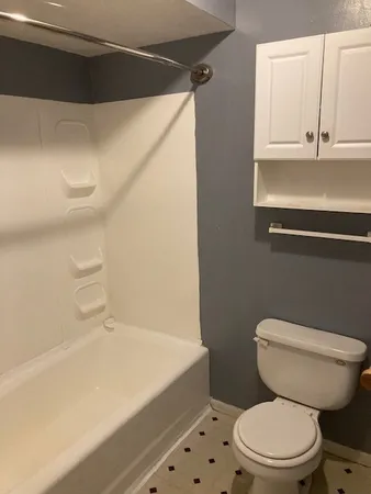 a bathroom with a sink a toilet and mirror