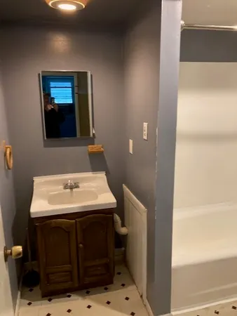 an empty room with a empty space and a chandelier fan