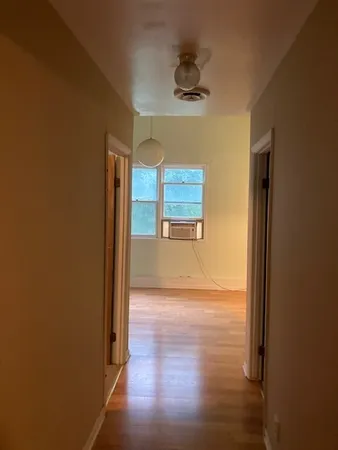 a view of an empty room with a fan