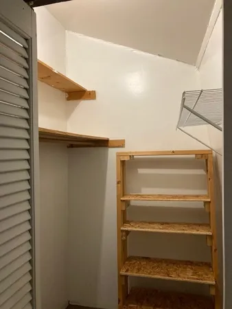 a view of a room with window and ceiling fan