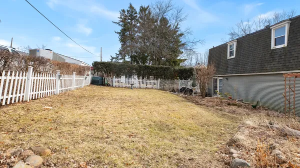 a view of a backyard with a tree
