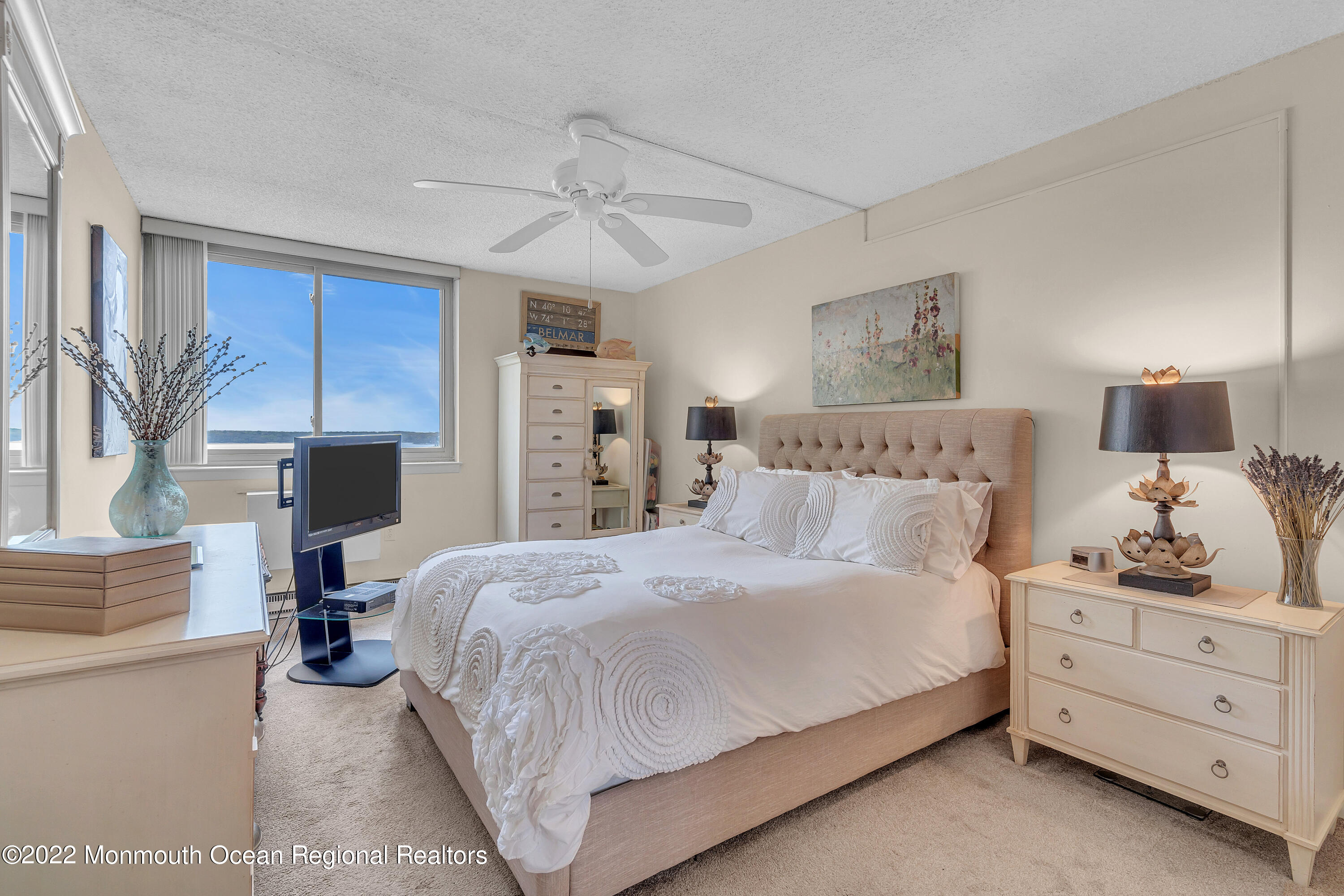 1000 River Road, Unit 7B Belmar, NJ 07719 - Photo 15 of 38 a bedroom with a bed and wooden floor