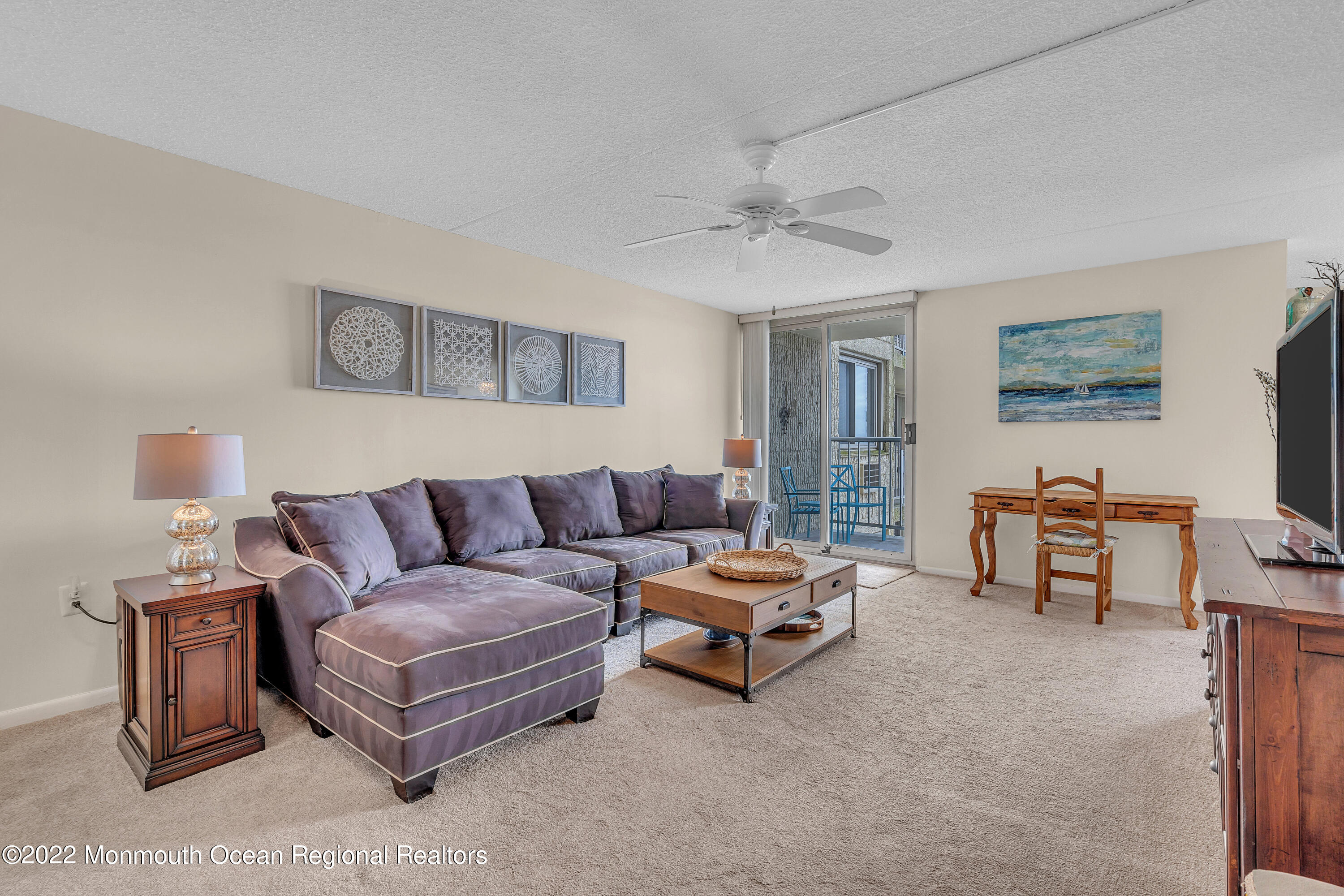 1000 River Road, Unit 7B Belmar, NJ 07719 - Photo 5 of 38 a living room with furniture and a ceiling fan