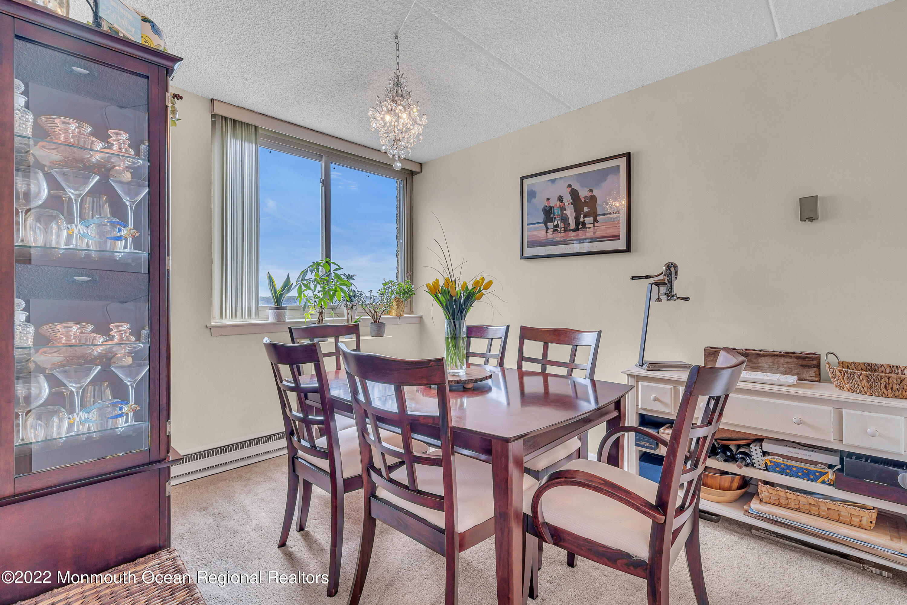 1000 River Road, Unit 7B Belmar, NJ 07719 - Photo 9 of 38 a view of a dining room with furniture and chandelier