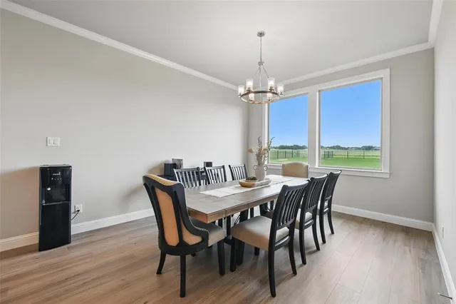 a kitchen with stainless steel appliances granite countertop a sink dishwasher and a stove with wooden floor