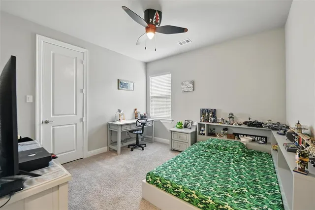 a bedroom with a bed and a desk